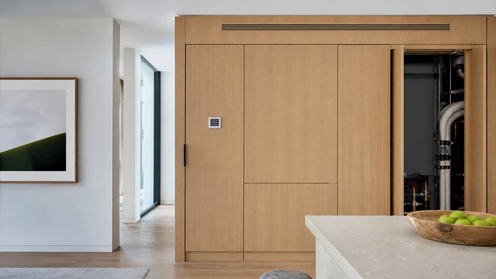 Refined interior with a linear ceiling diffuser, discreet control, and concealed organized mechanical cabinet